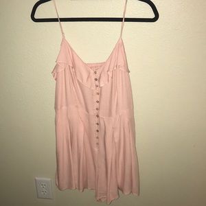 Pink romper with pleated skirt detail